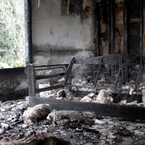 A burned living room after a house fire from a client of Blacktail Restoration.