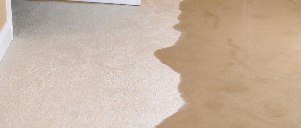 flooding water spreads quickly into a living room and causing water damage.