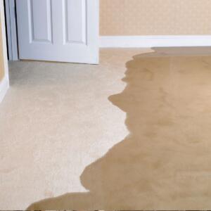 flooding water spreads quickly into a living room and causing water damage.